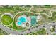 An overhead view of a community pool featuring a unique design and a vibrant gathering space with a clubhouse at 7277 W Adriatic Cir, Lakewood, CO 80227