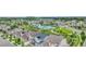 An aerial view of a well-maintained community pool and clubhouse nestled in a neighborhood with lush greenery and nearby city skyline at 7277 W Adriatic Cir, Lakewood, CO 80227