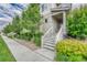 Inviting entrance with concrete steps, white railings, and manicured landscaping at 7277 W Adriatic Cir, Lakewood, CO 80227