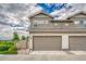Charming townhouse with a two-car garage, lush landscaping, and inviting curb appeal at 7277 W Adriatic Cir, Lakewood, CO 80227