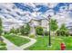 Beautiful townhomes featuring a well-manicured lawn, a walking path, and lush landscaping at 7277 W Adriatic Cir, Lakewood, CO 80227