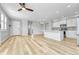 Living room showcasing an open floor plan, a modern kitchen, and lots of natural light at 7277 W Adriatic Cir, Lakewood, CO 80227
