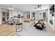 Bright living room featuring an open-concept design, a modern fireplace, and hardwood floors at 7277 W Adriatic Cir, Lakewood, CO 80227