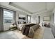 The main bedroom boasts a tray ceiling, neutral decor, and large windows with neighborhood views at 7277 W Adriatic Cir, Lakewood, CO 80227