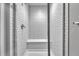 Walk-in shower with sleek, white subway tiles and a built-in bench for added comfort at 7277 W Adriatic Cir, Lakewood, CO 80227