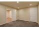 Finished basement boasts modern lighting, two white doors, and resilient concrete flooring at 13941 E Whitaker Dr, Aurora, CO 80015