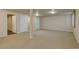 Spacious basement features neutral carpeting, recessed lighting, and multiple entryways at 13941 E Whitaker Dr, Aurora, CO 80015