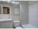 Well-lit bathroom featuring modern vanity, white toilet, shower-tub combo with tile surround, and mirrored medicine cabinet at 13941 E Whitaker Dr, Aurora, CO 80015