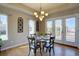 Cozy dining area with hardwood floors, modern lighting, and access to the deck at 13941 E Whitaker Dr, Aurora, CO 80015