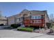 Charming stone-clad home with front porch, manicured landscaping, and a driveway at 13941 E Whitaker Dr, Aurora, CO 80015