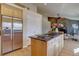 Open kitchen featuring stainless steel appliances, hardwood floors, and a breakfast bar at 13941 E Whitaker Dr, Aurora, CO 80015