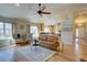 Inviting living room flows to kitchen, featuring hardwood floors and bright natural light at 13941 E Whitaker Dr, Aurora, CO 80015