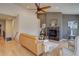 Cozy living room featuring a fireplace, hardwood floors, and a high ceiling with fan at 13941 E Whitaker Dr, Aurora, CO 80015