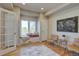 Sitting room with large window seat, natural light, and hardwood flooring at 13941 E Whitaker Dr, Aurora, CO 80015