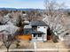 An aerial view shows the home's architecture and mature trees, neighborhood, and mountain views at 2111 S Franklin St, Denver, CO 80210