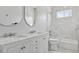 Elegant bathroom featuring double sinks, marble countertops, and a modern, tiled shower and bathtub at 2111 S Franklin St, Denver, CO 80210