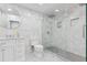 Modern bathroom features white tile, glass-enclosed shower with rain shower head, and vanity with vessel sink at 2111 S Franklin St, Denver, CO 80210