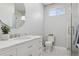 Bright bathroom with a spacious vanity, modern fixtures, and a glass-enclosed shower, offering a luxurious experience at 2111 S Franklin St, Denver, CO 80210
