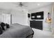Spacious bedroom features a ceiling fan, mounted TV, guitar, and dresser for ample storage at 2111 S Franklin St, Denver, CO 80210