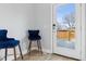 Inviting entryway featuring modern flooring, stylish blue chairs, and a bright doorway to the outside at 2111 S Franklin St, Denver, CO 80210