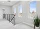 Bright hallway with modern railings, flooded with natural light from large windows, enhancing spacious feel at 2111 S Franklin St, Denver, CO 80210