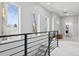 Upstairs hallway with large windows providing natural light and view, and black iron railing at 2111 S Franklin St, Denver, CO 80210