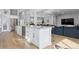 Kitchen island with stainless steel appliances and view into living area at 2111 S Franklin St, Denver, CO 80210