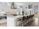 Open kitchen with stainless steel appliances, a large island, and barstool seating at 2111 S Franklin St, Denver, CO 80210