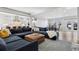 Open concept living room with hardwood floors and large sectional sofa at 2111 S Franklin St, Denver, CO 80210