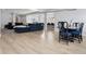 Open concept living room with sleek modern furniture and an attached dining area and kitchen at 2111 S Franklin St, Denver, CO 80210