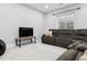 Cozy recreation room with a plush sectional couch, large TV, and ample seating, perfect for relaxation at 2111 S Franklin St, Denver, CO 80210