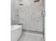 Luxurious shower with dual shower heads, gray accent tiles, and a glass door, adjacent to soaking tub at 2111 S Franklin St, Denver, CO 80210