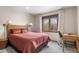 Cozy bedroom with natural light, a dedicated desk space, and neutral tones at 7712 S Monaco E Cir, Centennial, CO 80112