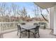 View of a wood deck with an outdoor table and seating, surrounded by mature trees and neighborhood views at 7712 S Monaco E Cir, Centennial, CO 80112