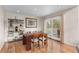 Bright dining room features hardwood floors, sliding door access to the balcony, and stylish shelving at 7712 S Monaco E Cir, Centennial, CO 80112