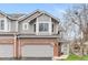 Charming townhome with gray siding, brick accents, and a well-maintained front yard, perfect for comfortable living at 7712 S Monaco E Cir, Centennial, CO 80112
