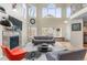 Sun-filled living room boasting high ceilings, a fireplace, and large windows at 7712 S Monaco E Cir, Centennial, CO 80112