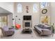Elegant living room featuring a fireplace, plush seating, and abundant natural light at 7712 S Monaco E Cir, Centennial, CO 80112