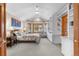 Spacious main bedroom with built-in bookshelves, plush carpet, and a sitting area at 7712 S Monaco E Cir, Centennial, CO 80112