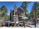 Stunning home featuring an expansive deck with outdoor seating and a charming exterior design against a wooded backdrop at 160 Bristlecone Way, Boulder, CO 80304