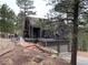 Beautiful home with multiple decks and a two-car garage, surrounded by lush greenery and mature trees at 160 Bristlecone Way, Boulder, CO 80304