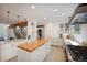 Stylish kitchen features a wood-topped island, white cabinets, and stainless steel appliances at 160 Bristlecone Way, Boulder, CO 80304