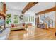Bright living room with wood floors, fireplace, built-ins, and scenic backyard views at 160 Bristlecone Way, Boulder, CO 80304