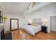 Bright main bedroom featuring a skylight, hardwood floors, and ensuite bathroom at 160 Bristlecone Way, Boulder, CO 80304