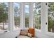 A cozy reading nook is framed by scenic views of snow-covered trees outside at 160 Bristlecone Way, Boulder, CO 80304