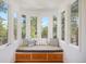 Bay window reading nook with bench seating overlooking beautiful tree view at 160 Bristlecone Way, Boulder, CO 80304