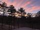 Scenic sunset view from a wooden deck with metal railings, showcasing colorful skies and serene natural beauty at 160 Bristlecone Way, Boulder, CO 80304