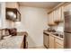 Well-lit kitchen with stainless steel appliances, granite countertops, and light wood cabinetry at 2345 N Clay St # 6, Denver, CO 80211