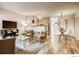 Open-concept living room featuring hardwood floors and adjacent dining area at 2345 N Clay St # 6, Denver, CO 80211
