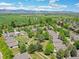 An aerial view shows this neighborhood's green spaces and picturesque mountain views at 946 Champion Cir, Longmont, CO 80503